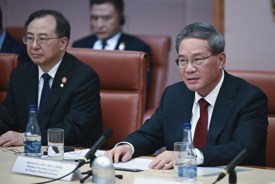 Chinese Premier Li Qiang, right, speaks across the table to Australian Prime Minster Anthony Albanese during a leaders meeting at Parliament House in Canberra, Australia, Monday, June 17, 2024. Li, Albanese and senior ministers of both administrations met at Parliament House on Monday to discuss thorny issues, including lingering trade barriers, conflict between their militaries in international waters and China's desire to invest in critical minerals. (Lukas Coch/Pool Photo via AP)