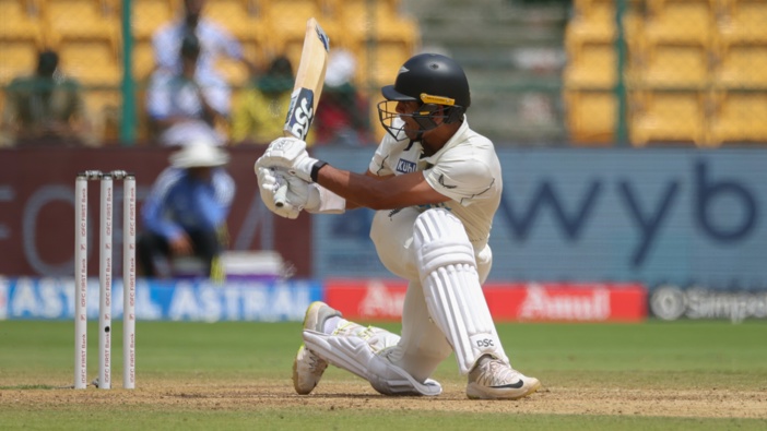 Rachin Ravindra of New Zealand sweeps to reach a century during day three of the First Test match between India and New Zealand at M. Chinnaswamy Stadium on October 18, 2024 in Bengaluru, India. (Photo by Abhishek Chinnappa/Getty Images)
