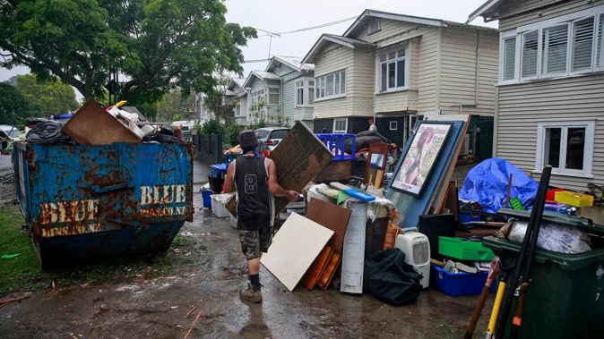 Residents of Dryden St in Grey Lynn clean up in the aftermath of the storms and flooding over the weekend. Photo / Alex Burton