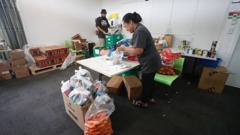 Preparing food packages at the Emergency Management Support Hub in West Henderson. Photo / Dean Purcell