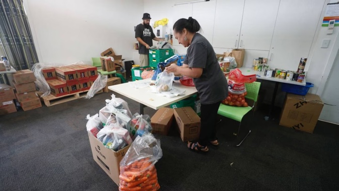 Preparing food packages at the Emergency Management Support Hub in West Henderson. Photo / Dean Purcell