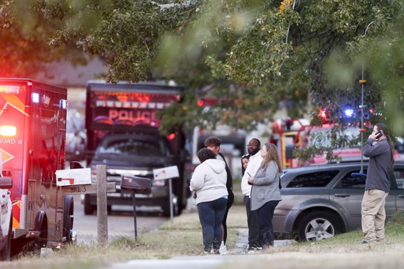 People look on as Broken Arrow, Okla., police and fire department investigate the scene of a fire with multiple fatalities. Photo / AP