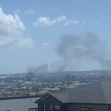 The fire has closed a major road and left homes and businesses without power.
