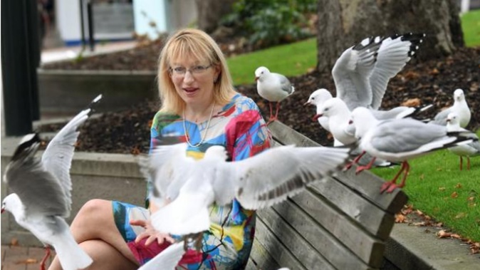 Dunedin city councillor Sophie Barker, flocked by red-billed gulls in the Octagon yesterday, says we need to learn to love our airborne neighbours. Photo / Stephen Jaquierry