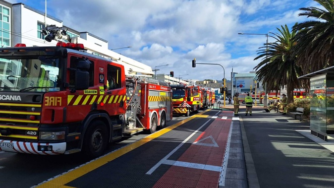 Several Fire and Emergency trucks are parked on Adelaide Rd.