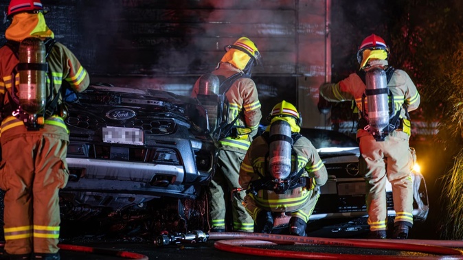Fire crews were called to a blaze involving two cars, one an EV, in the early hours of this morning. Photo / Hayden Woodward
