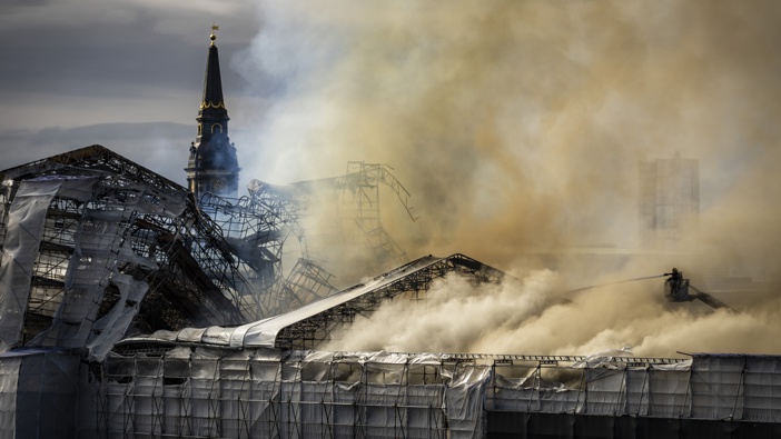 Firefighters work as smoke rises out of the Old Stock Exchange in Copenhagen, Denmark, Tuesday, April 16, 2024. Photo / AP