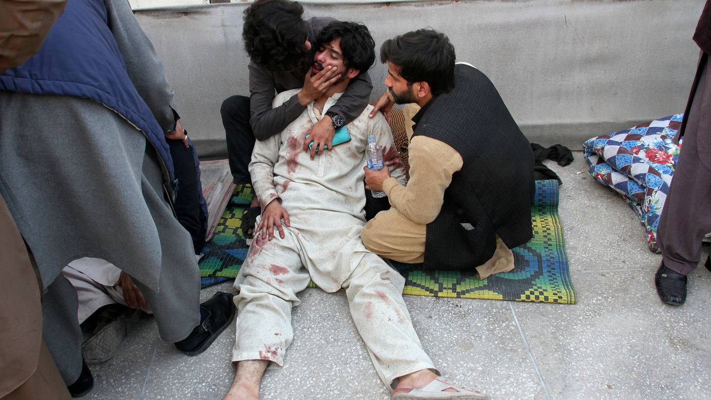 A man is comforted as he mourns the death of a family member at a hospital following a bomb explosion in Peshawar, Pakistan. (Photo / AP)