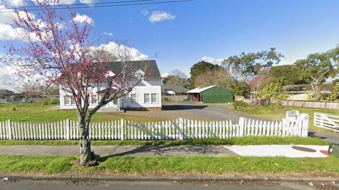 The Norfolk Island Pine at 225 St George St, Papatoetoe was reduced to a stump, visible to the right of the driveway above, after it was illegally felled. This is the property in August, 2022. Image / Google Maps