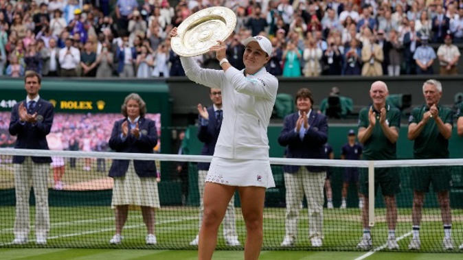 Australia's Ashleigh Barty poses with the trophy for the media after winning the women's singles final. (Photo / AP)