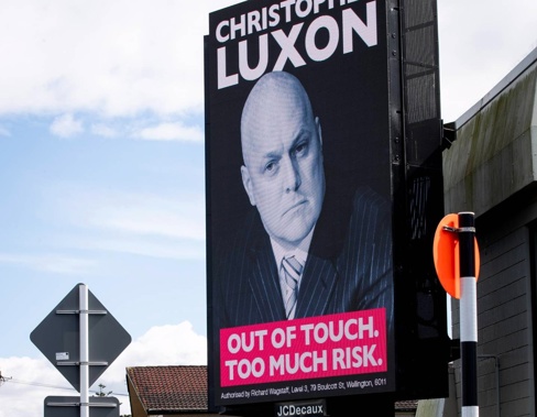 A digital billboard on the corner of Sandringham Rd and St Lukes Rd featuring Christopher Luxon and the slogan "Out of touch. Too much risk.". Photo / Jason Oxenham