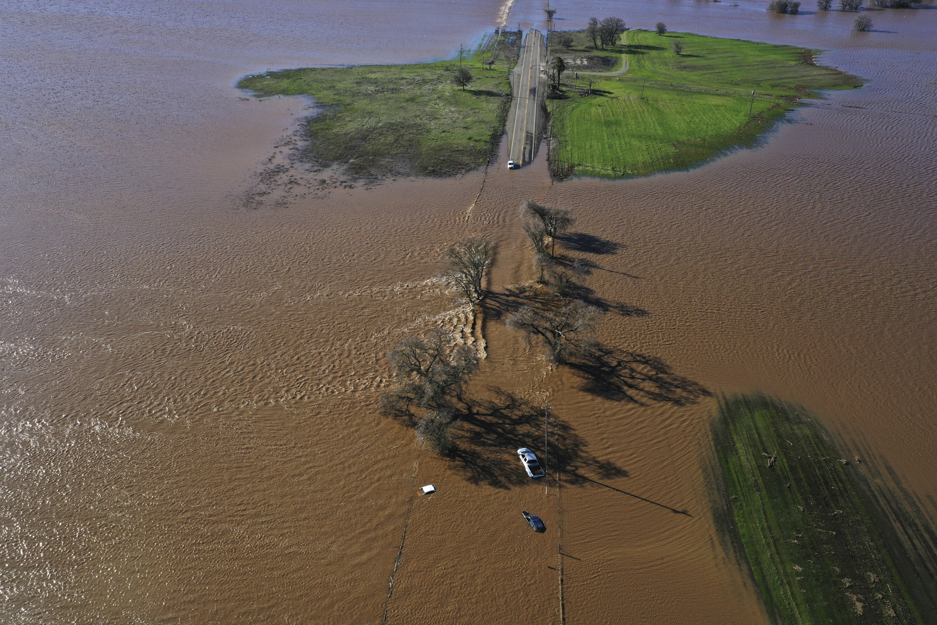Three vehicles are submerged on Dillard Road west of Highway 99 in south Sacramento County in Wilton, Calif., Sunday, Jan. 1, 2023, after heavy rains on New Year's Eve produced levee breaks. Photo / AP