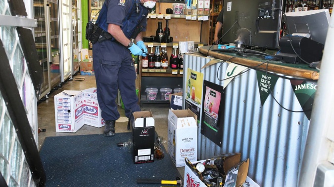 Senior Constable Ryan Bailey at Liquorland Otaika after the burglary. Photo / Tania Whyte