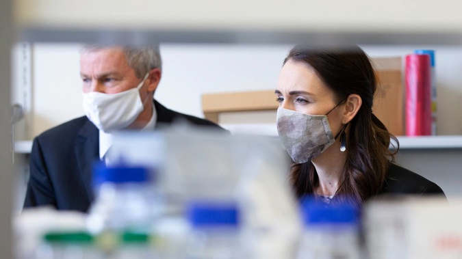 Prime Minister Jacinda Ardern tours Wellington's Malaghan Institute of Medical Research with director Professor Graham Le Gros. A Kiwi-made booster could be trialled by late 2022. (Photo / Getty Images)