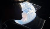 Artemis II mission specialist Christina Koch looks back at Earth through the window of the Orion spacecraft. Photo / Nasa, AFP