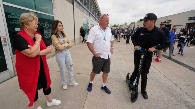 Scott McLaughlin, right, of New Zealand, talks with his parents Wayne and Diane McLaughlin, and his wife Karly, second from left, before qualifications for the Indianapolis 500. Photo / AP