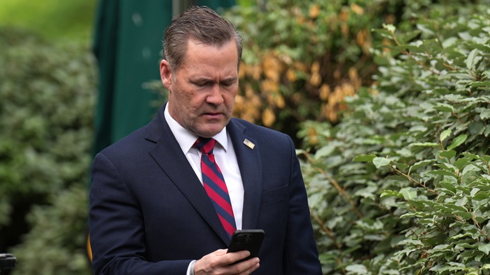 National Security Advisor Michael Waltz looks at his phone as he prepares for a TV interview at the White House on May 01, 2025 in Washington, DC. (Photo by Andrew Harnik/Getty Images)