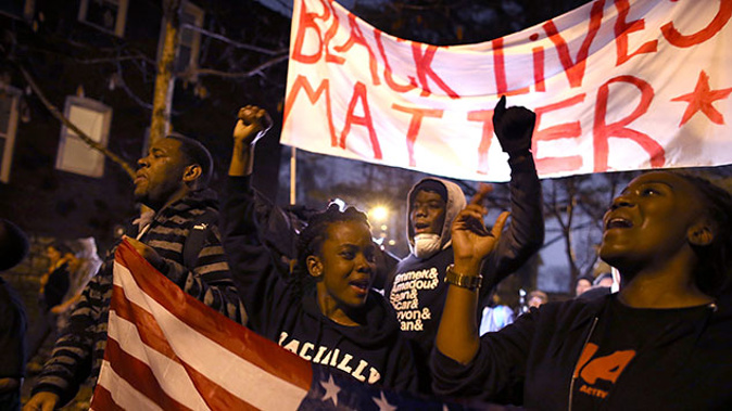 Demonstrators march through the streets while protesting the shooting death of 18-year-old Michael Brown on November 23, 2014 (Getty Images)