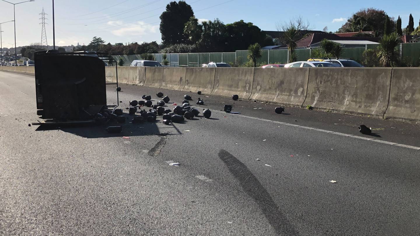 Debris has spilled out over the road after a crash on State Highway 1 in Auckland. Photo / Dean Purcell