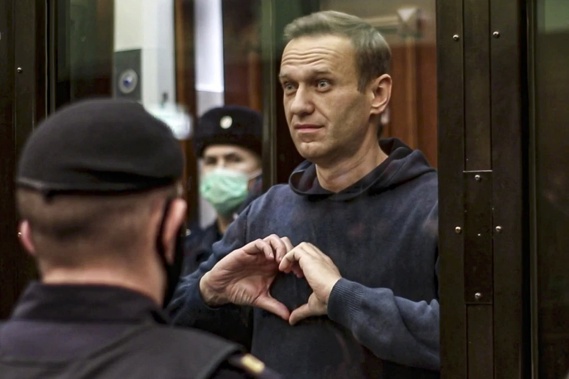 In this handout photo taken from video provided by the Moscow City Court on Feb. 2, 2021, Russian opposition leader Alexei Navalny shows a heart symbol while standing in a defendants’ cage during a hearing in the Moscow City Court in Moscow, Russia. President Vladimir Putin says he supported an idea to release Navalny in a prisoner exhcnage just days before the man who was his biggest foe died. Photo / AP