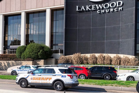 Emergency vehicles line the feeder road outside Lakewood Church during a reported active shooter event. Photo / AP
