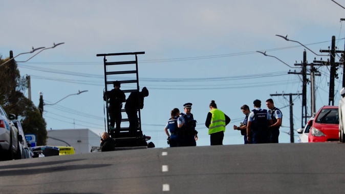 Armed police have descended on a street in the Auckland suburb of Mt Roskill. Photo / Dean Purcell.