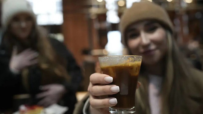 People drinking coffee at the Starbucks coffee shop in Milan, Italy. Photo / AP
