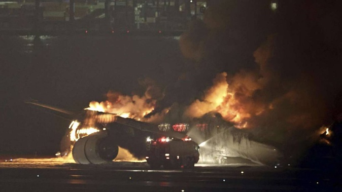 A Japan Airlines plane is on fire on the runway of Tokyo’s Haneda airport. Photo / AP