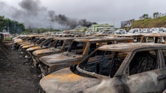 Burnt cars are lined up after riots in Noumea, New Caledonia on Wednesday. France has imposed a state of emergency in the French Pacific territory, boosting security forces' powers to quell unrest that has left five people dead, erupting after protests over voting reforms. Photo / AP