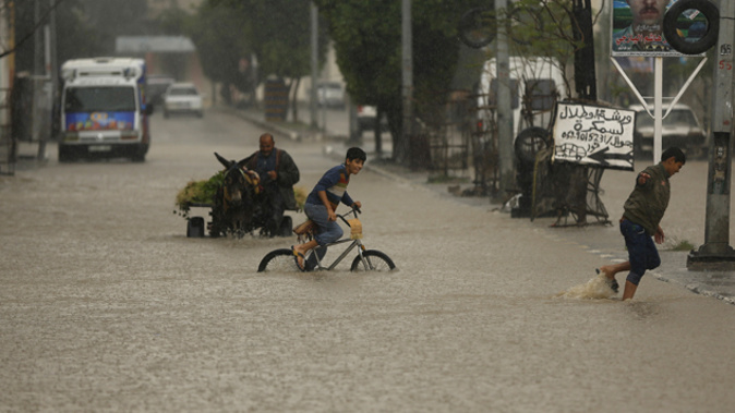 Children play among the flooded Gaza city (Getty Images)