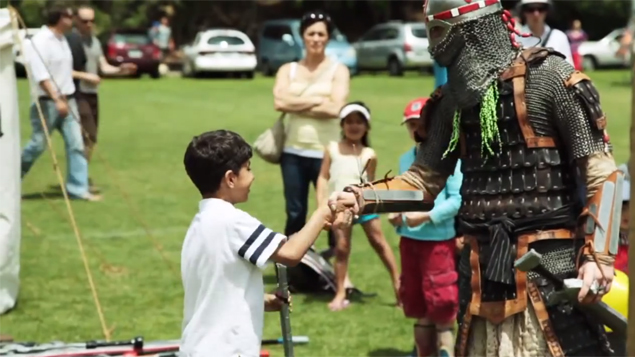 A knight shakes hands with a young prospect (YouTube)