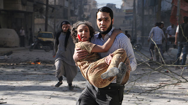 A man carries a wounded girl following a reported bombardment with explosive-packed 'barrel bombs' by Syrian government forces in the Al-Mowasalat neighborhood in the northern Syrian city of Aleppo on April 27, 2014.  (Getty Images)