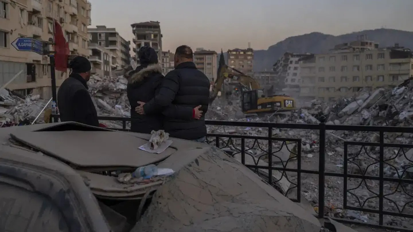 Men observe the site of collapsed buildings during the earthquake in Antakya, southeastern Turkey. Photo / AP