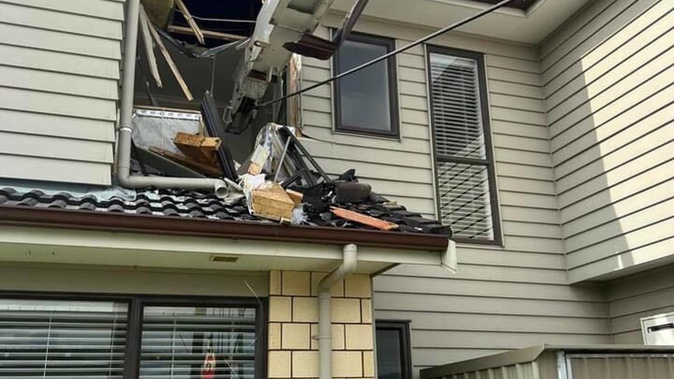 A crane working on a construction site at Oteha Valley School toppled, crashing into a neighbouring home. (Photo / Supplied)
