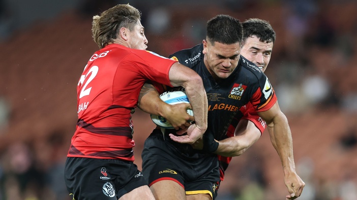 Quinn Tupaea of the Chiefs is tackled during the round two Super Rugby Pacific match between Chiefs and Crusaders at FMG Stadium, on February 21, 2025, in Hamilton, New Zealand. (Photo by Phil Walter/Getty Images)