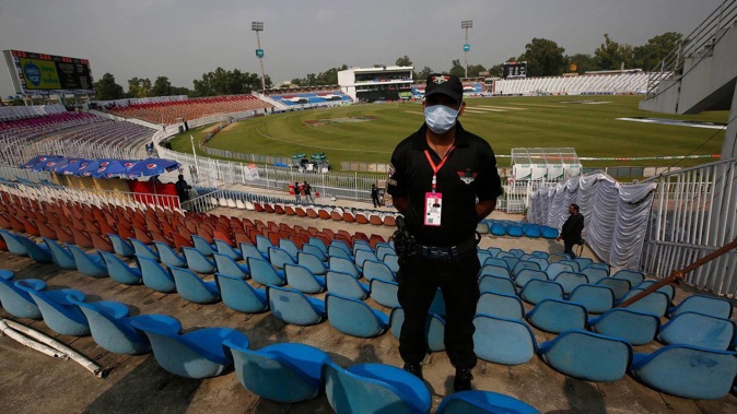 A Pakistani police officer stands guard an enclosure of the Pindi Cricket Stadium, where play between the Black Caps and Pakistan didn't begin due to a security threat. (Photo / AP)