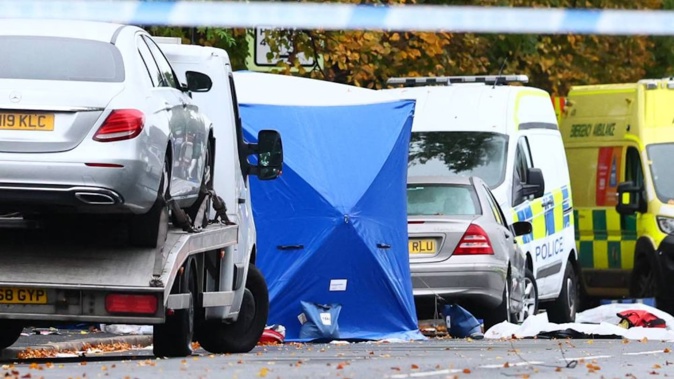 Police tents cover parts of the scene on the main road outside Heaton Park Hebrew Congregation synagogue in Crumpsall, north Manchester, following an attack at the synagogue yesterday. Photo / Paul Currie, AFP