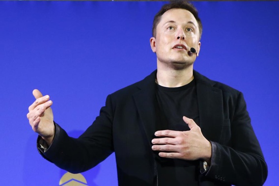 Tesla Motors, Inc. CEO Elon Musk speaks at the Paris Pantheon Sorbonne University as part of the COP21, United Nations Climate Change Conference in Paris on Dec. 2, 2015. An early prototype of Tesla Inc.'s proposed Optimus humanoid robot slowly and awkwardly walked onto a stage, turned, and waved to a cheering crowd at the company's artificial intelligence event Friday, Sept. 30, 2022. (AP Photo/Francois Mori, File)