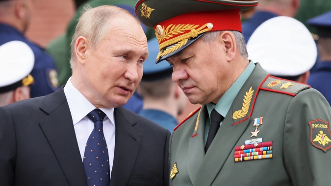 Russian President Vladimir Putin speaks with Russian Defence Minister Sergei Shoigu. Photo / AP