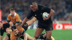 Blockbusting Jonah Lomu fends off Wallabies tacklers. Photo / Getty Images