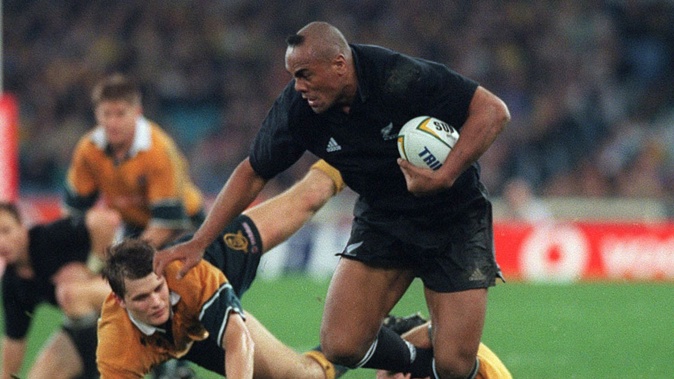 Blockbusting Jonah Lomu fends off Wallabies tacklers. Photo / Getty Images