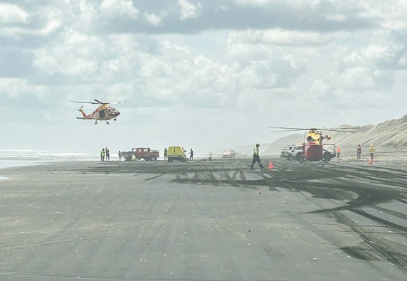 Emergency services on Muriwai Beach on January 21 after a car rolled, ejecting a passenger from the vehicle.