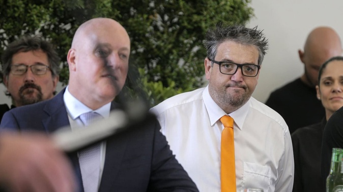 Prime Minister Christopher Luxon (left) pictured with convicted fraudster Aaron Drever (yellow tie) at the official opening of Parnell retirement village The Foundation in March. Photo / Alex Burton