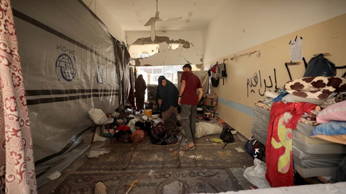 Palestinians inspect the area after an Israeli attack hit al-Zahraa School in the east of Gaza City. Photo / Anadolu via Getty Images