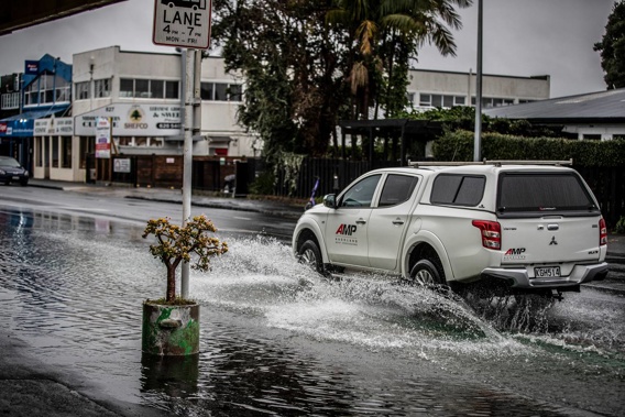 Flooded roads caused traffic delays in the city during a sudden downpour. Photo / Michael Craig