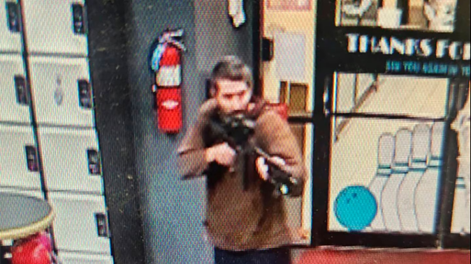 In this image taken from video released by the Androscoggin County Sheriff's Office, an unidentified shooter points a gun. Photo / AP