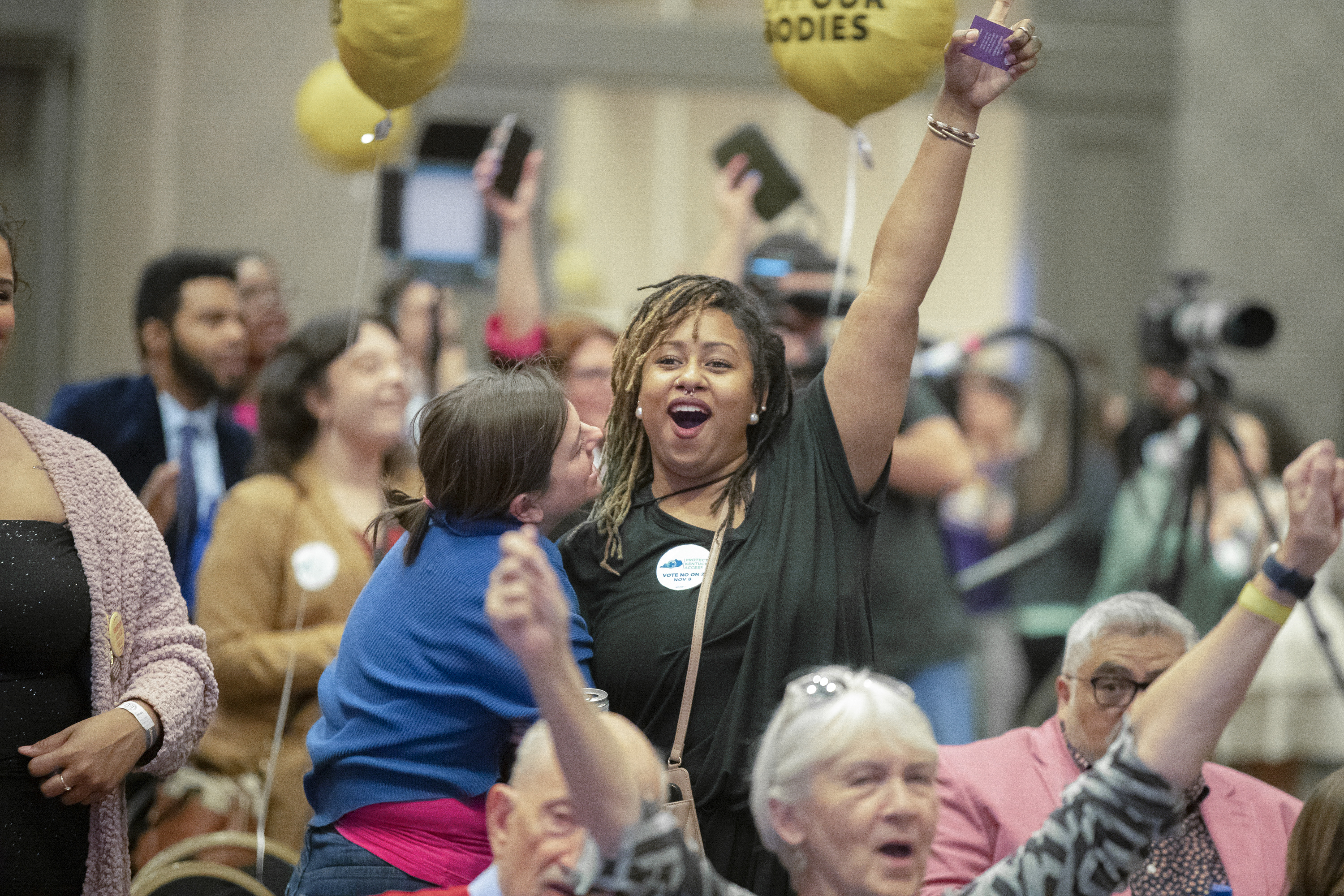 Amira Bryant, with arm extended, celebrates after it's announced on television that Kentucky Amendment 2 is likely to be defeated during a Protect Kentucky Access' election watch party at the Galt House in Louisville, Ky. Photo / AP
