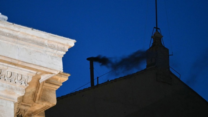 Black smoke rises from the chimney of the Sistine Chapel, signalling that cardinals have failed to elect a new pope in the first ballot of their conclave in the Vatican. Photo / AFP
