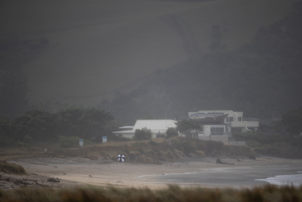 Beachgoers make their way off the Simpsons Beach, Whitianga. Photo / Hayden Woodward