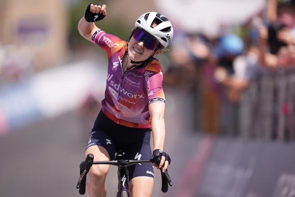 Niamh Fisher-Black celebrates as she cycles to the finish line to win the third stage of the Giro d’Italia Women in July. Photo / Photosport